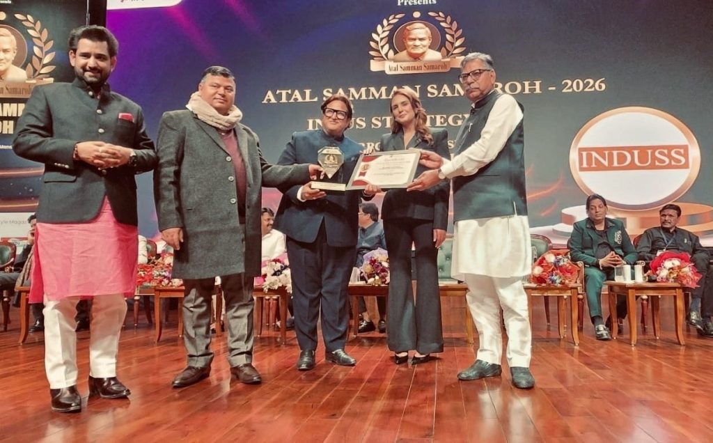 Manish Chaturvedi with the Atal Samman trophy and certificate at the grand backdrop of Atal Samman Samaroh 2026, Bharat Mandapam, New Delhi
